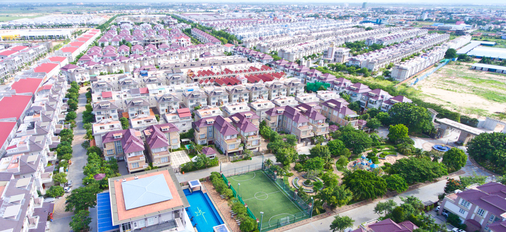 Aerial view over The Star Platinum showing rows of completed villas, a sports field and swimming pool