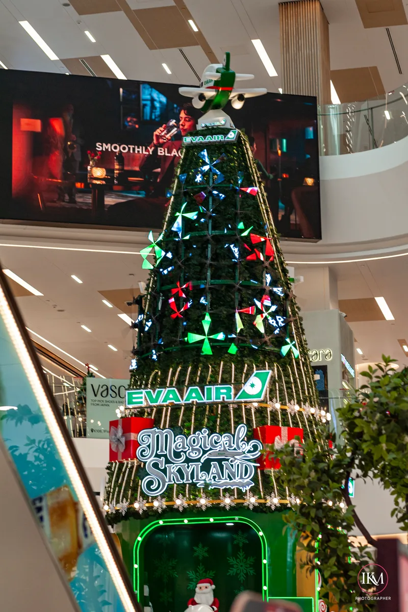 Multi-level interior atrium of Chip Mong 271 Mega Mall with a tall festive display