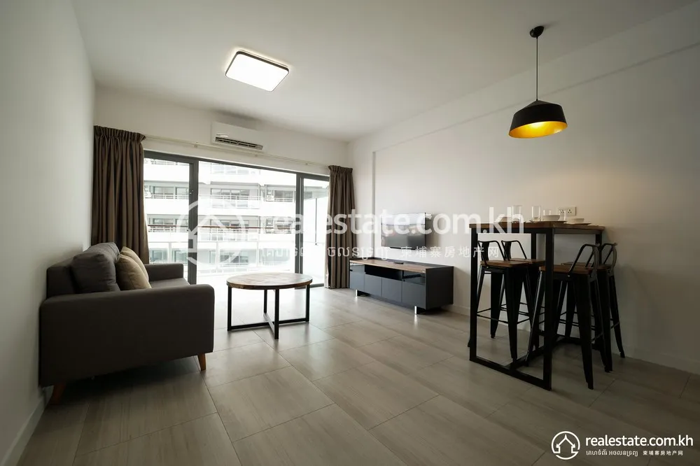 Furnished living room in a Bodaiju Residences unit with balcony facing the opposite block