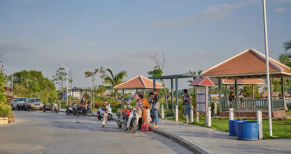 Residents at the lakeside park gazebos inside Borey Maha Sen Sok