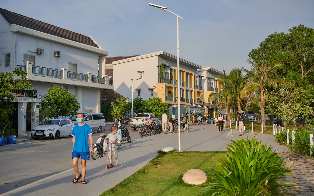 Evening streetscape with residents walking inside Borey Maha Sen Sok