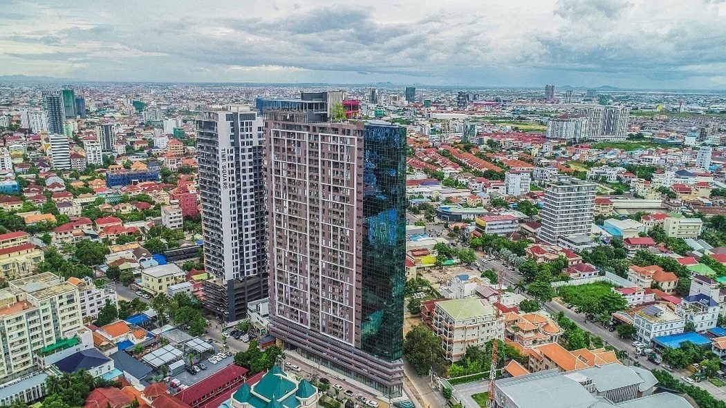 Aerial view of the completed Time Square towers amid low-rise Phnom Penh housing