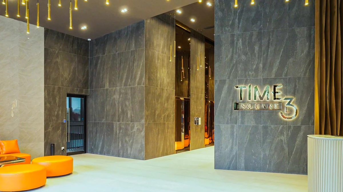 Furnished unit interior inside Time Square 3 with city views through floor-to-ceiling windows