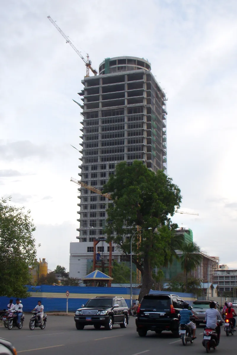 Canadia Tower under construction in 2008 with a tower crane, viewed from street level with traffic