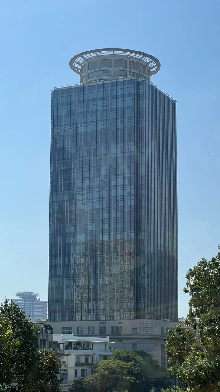 Canadia Tower exterior in Phnom Penh, showing its distinctive glass facade and circular roof crown