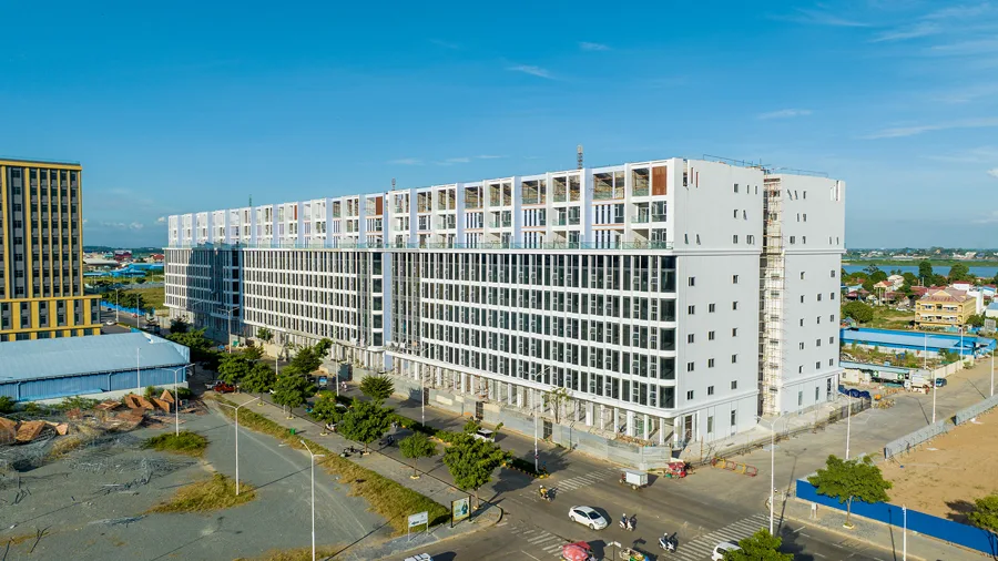 Large white apartment block of the Chroy Changvar satellite city with the Tonle Sap river behind