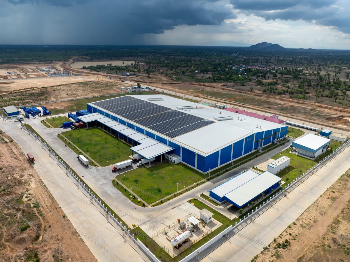 Drone aerial of the Techo International Airport terminal complex and surrounding empty land parcels
