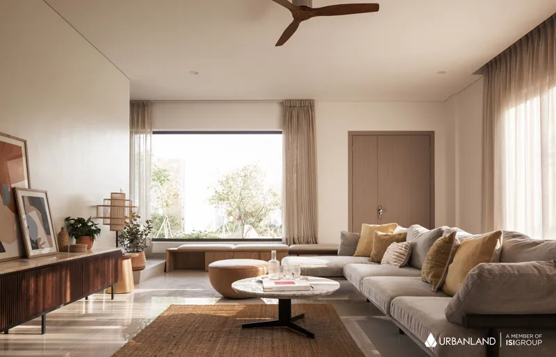 Furnished show-home living room at Borey Chankiri with neutral tones, large windows and garden view