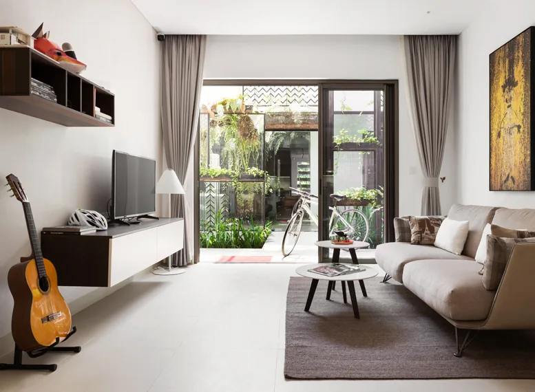 Furnished Embassy Central show-unit living room opening onto a planted terrace