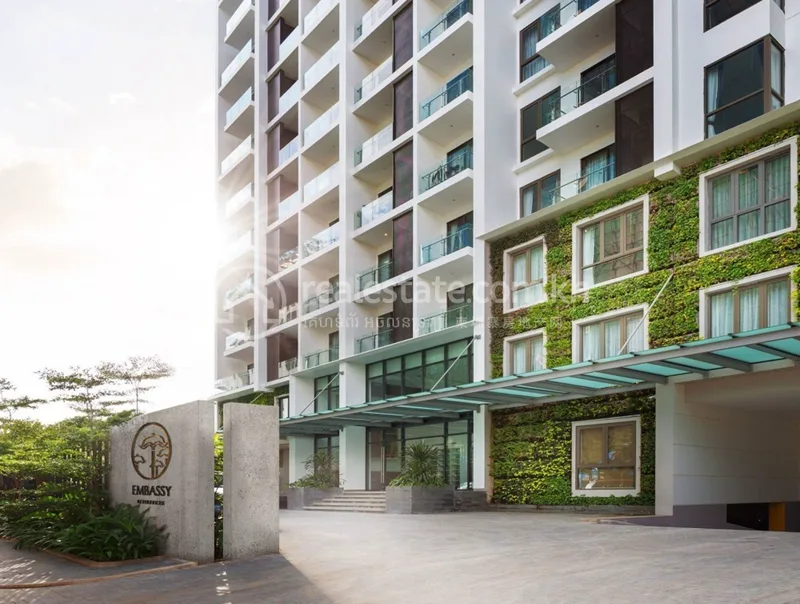 Embassy Residences ground-floor entrance with vertical garden wall and monument signage