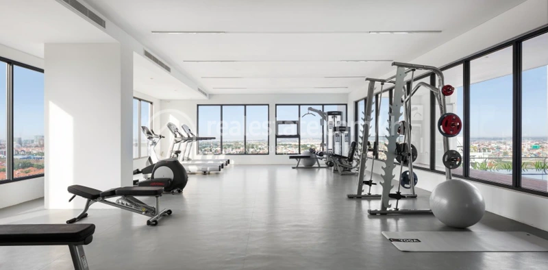 Top-floor fitness centre at Embassy Residences with panoramic windows over Phnom Penh