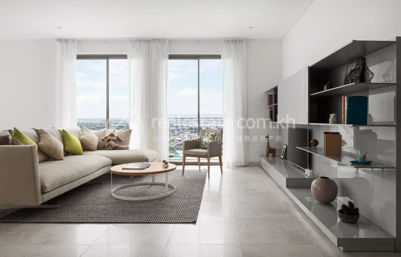 Furnished living room of an Embassy Residences condominium with floor-to-ceiling windows and city views
