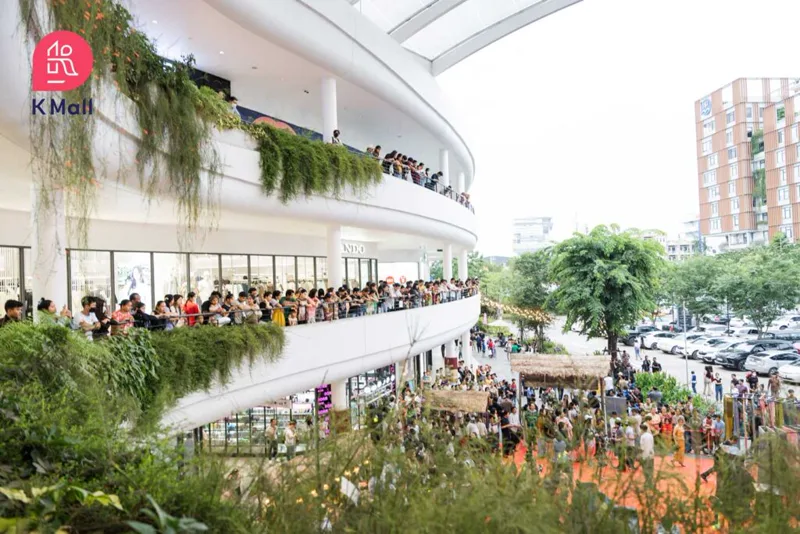 Crowds on the terraced, greenery-draped balconies of K Mall at ISI Park, Veng Sreng